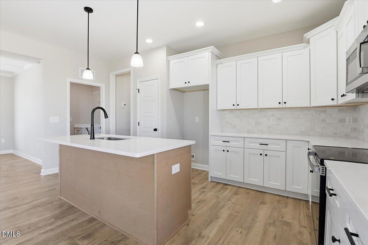 3696 Drew Farmer Road La Grange, NC 28551 - Photo 10 of 35 a kitchen with white cabinets appliances and sink
