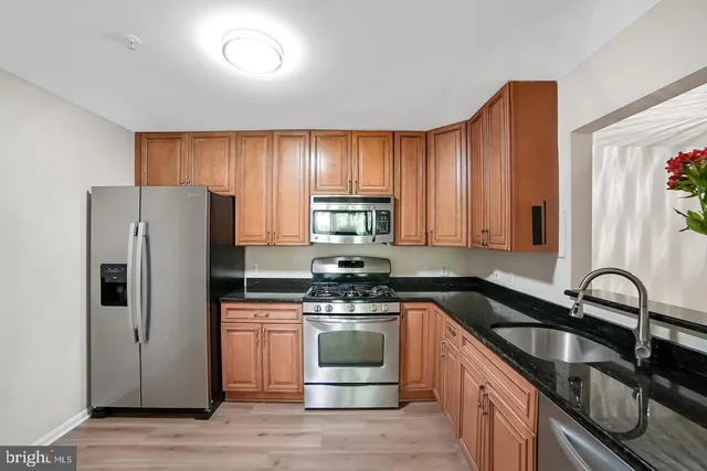 a kitchen with a refrigerator and a sink
