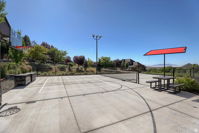 828 South Deer Road Tooele, UT 84074 - Photo 39 of 51 Concrete sport court featuring a basketball hoop and net