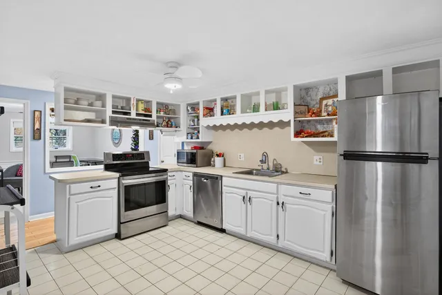 a kitchen with stainless steel appliances granite countertop a refrigerator sink and cabinets