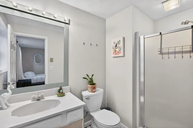 a bathroom with a sink toilet and shower