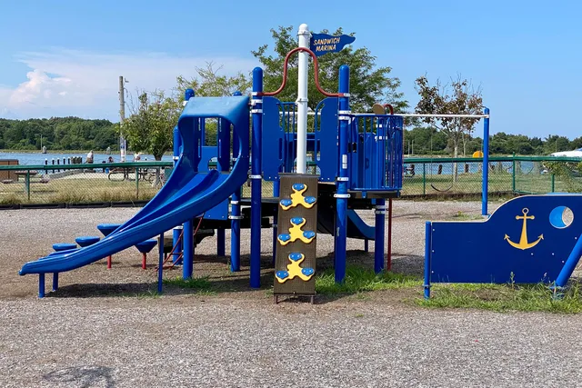 a wooden bench sitting in front of a house