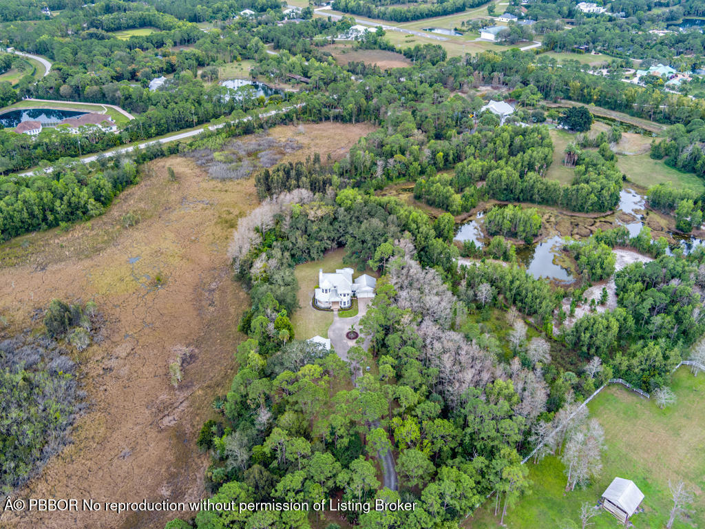 1001 Southeast Ranch Road Northeast Jupiter, FL 33478 - Photo 31 of 32 an aerial view of a houses with a yard