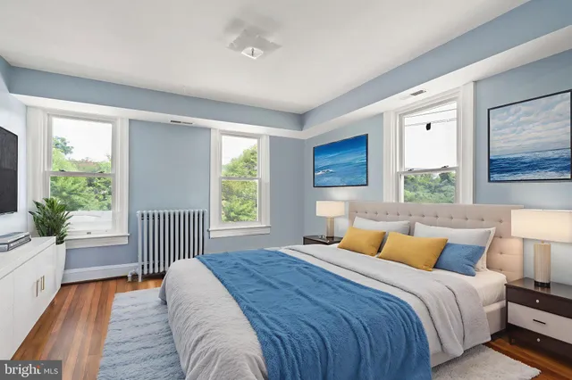 a bedroom with a bed and a large window