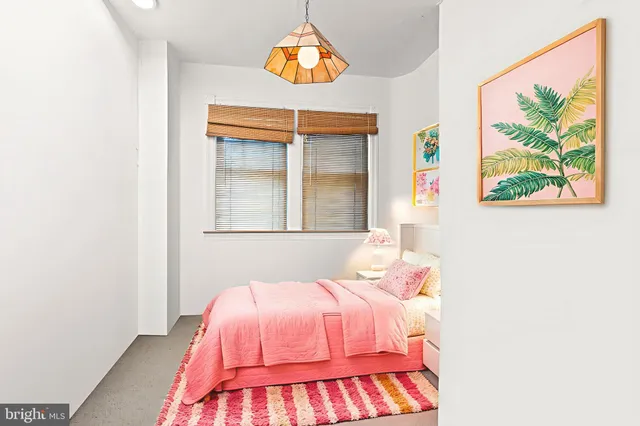 a bedroom with a bed and a painting on the wall