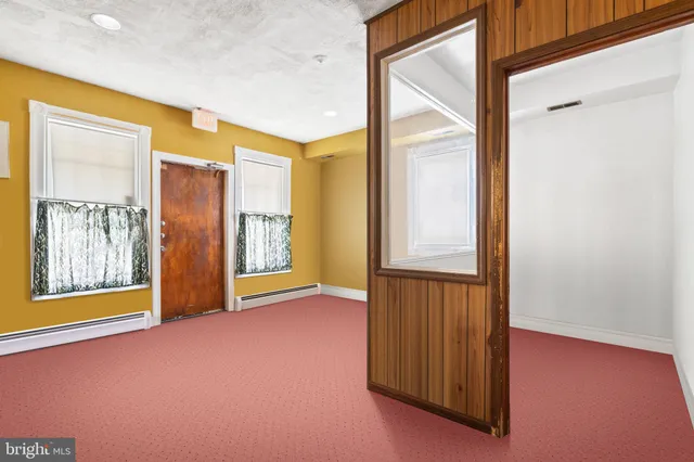 a view of an empty room with glass door