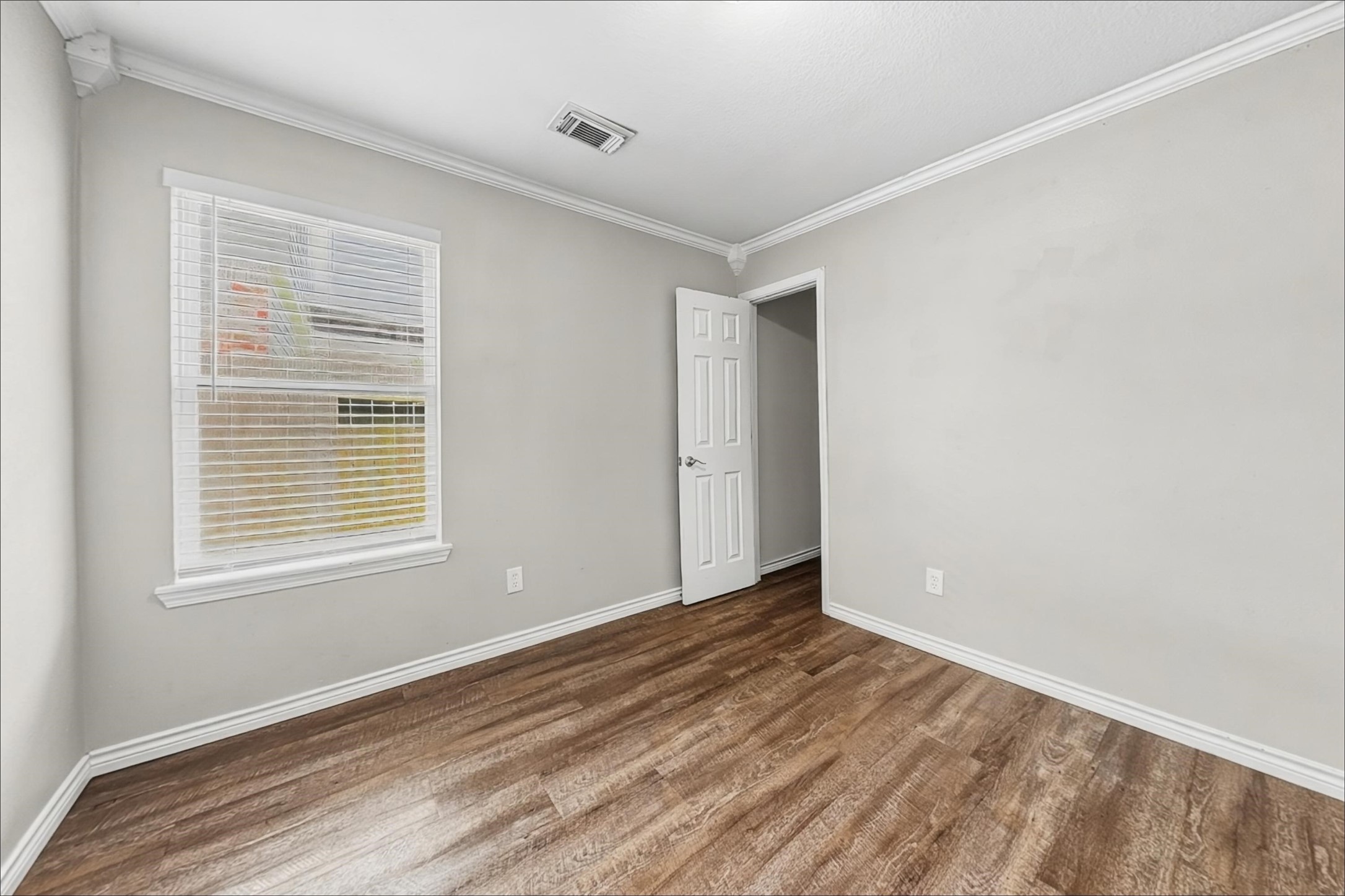 2423 Lofty Falls Court Spring, TX 77386 - Photo 14 of 15 a view of an empty room with wooden floor and a window