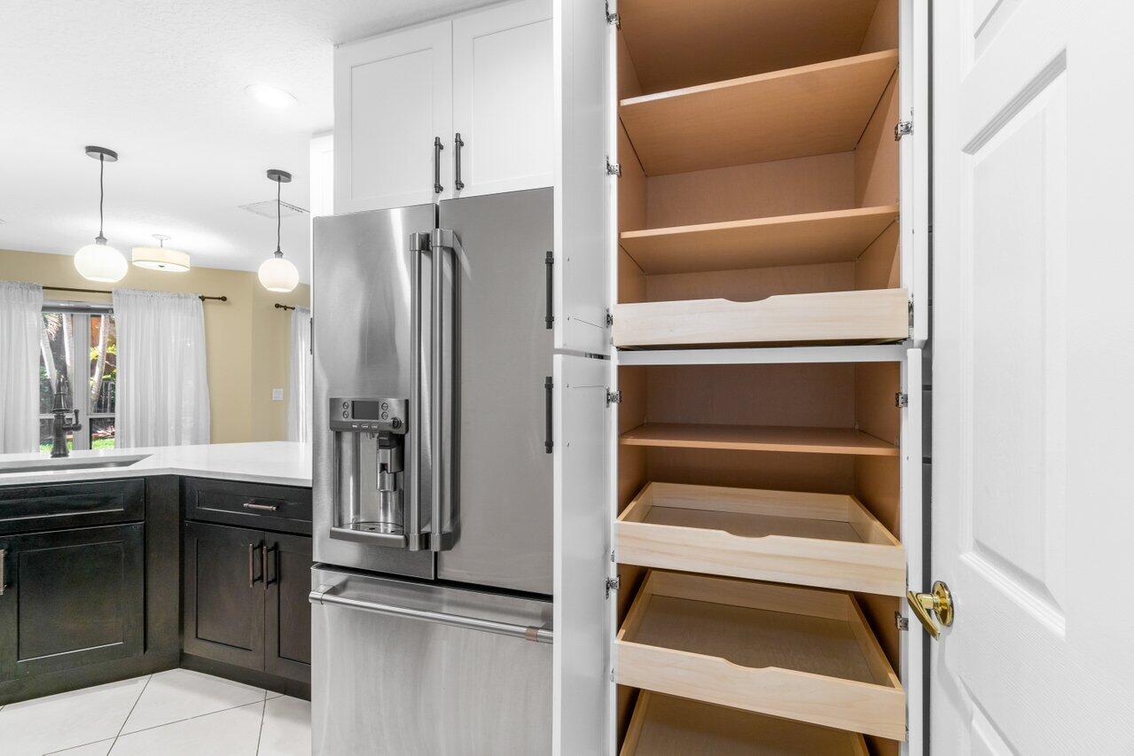 23458 Torre Circle Boca Raton, FL 33433 - Photo 12 of 36 a kitchen with a refrigerator and a sink