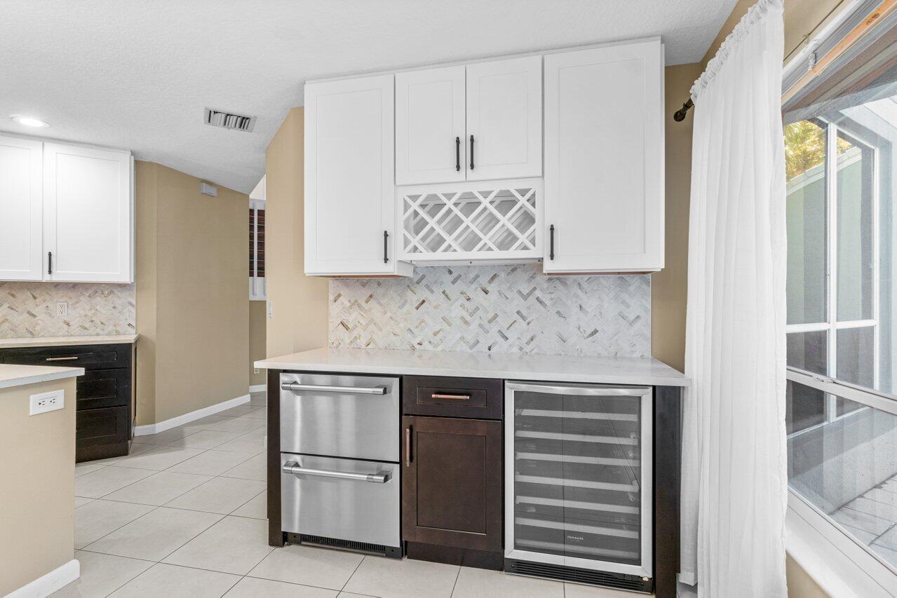23458 Torre Circle Boca Raton, FL 33433 - Photo 13 of 36 a kitchen with stainless steel appliances granite countertop a stove and a refrigerator