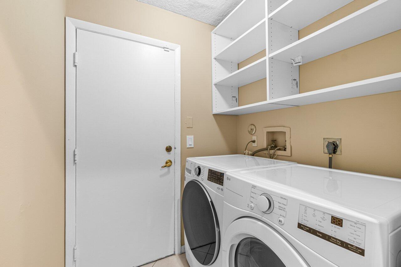 23458 Torre Circle Boca Raton, FL 33433 - Photo 21 of 36 a utility room with dryer and washer