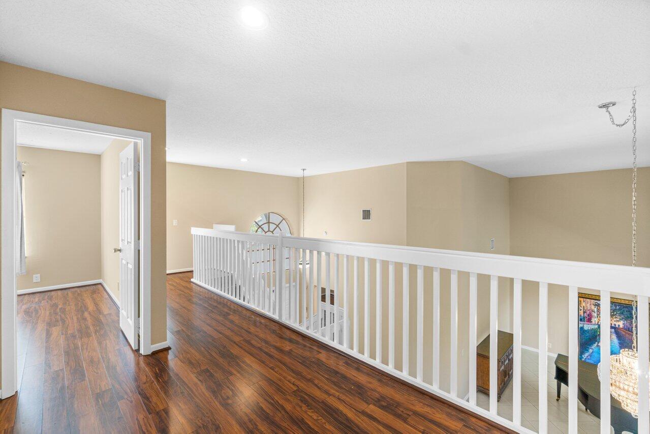 23458 Torre Circle Boca Raton, FL 33433 - Photo 24 of 36 a view of a hallway with wooden floor