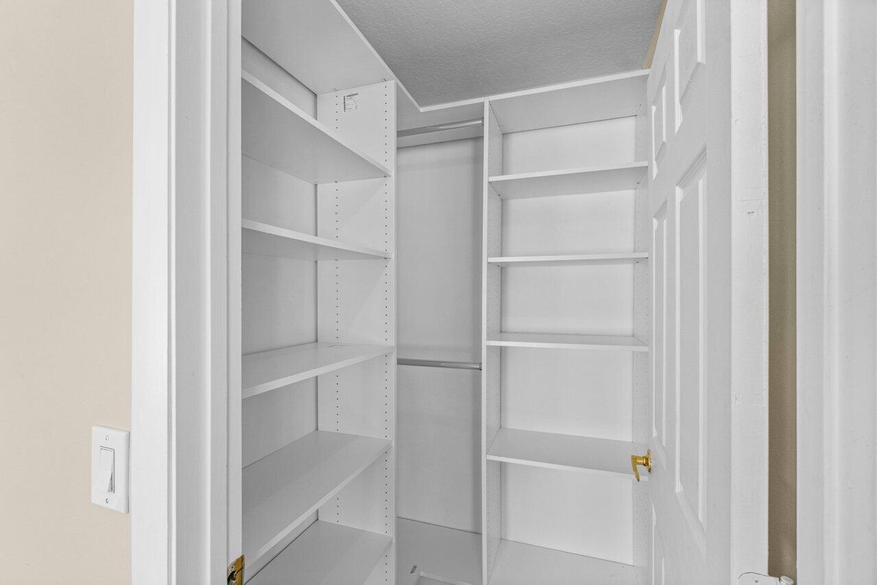 23458 Torre Circle Boca Raton, FL 33433 - Photo 26 of 36 a view of walk in closet with empty racks