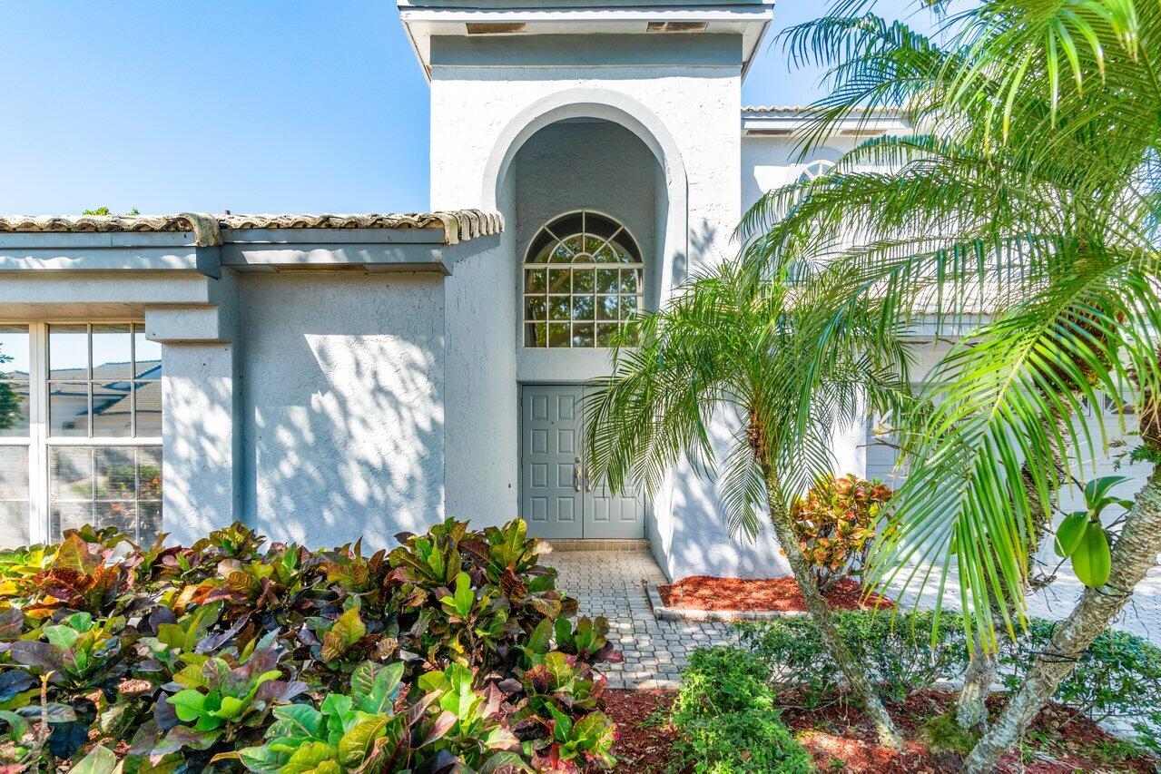 23458 Torre Circle Boca Raton, FL 33433 - Photo 3 of 36 a front view of a house with a garden