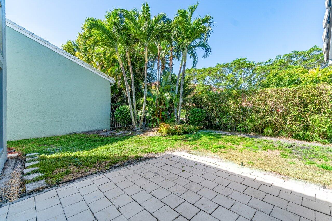 23458 Torre Circle Boca Raton, FL 33433 - Photo 32 of 36 a view of backyard with potted plants and large trees
