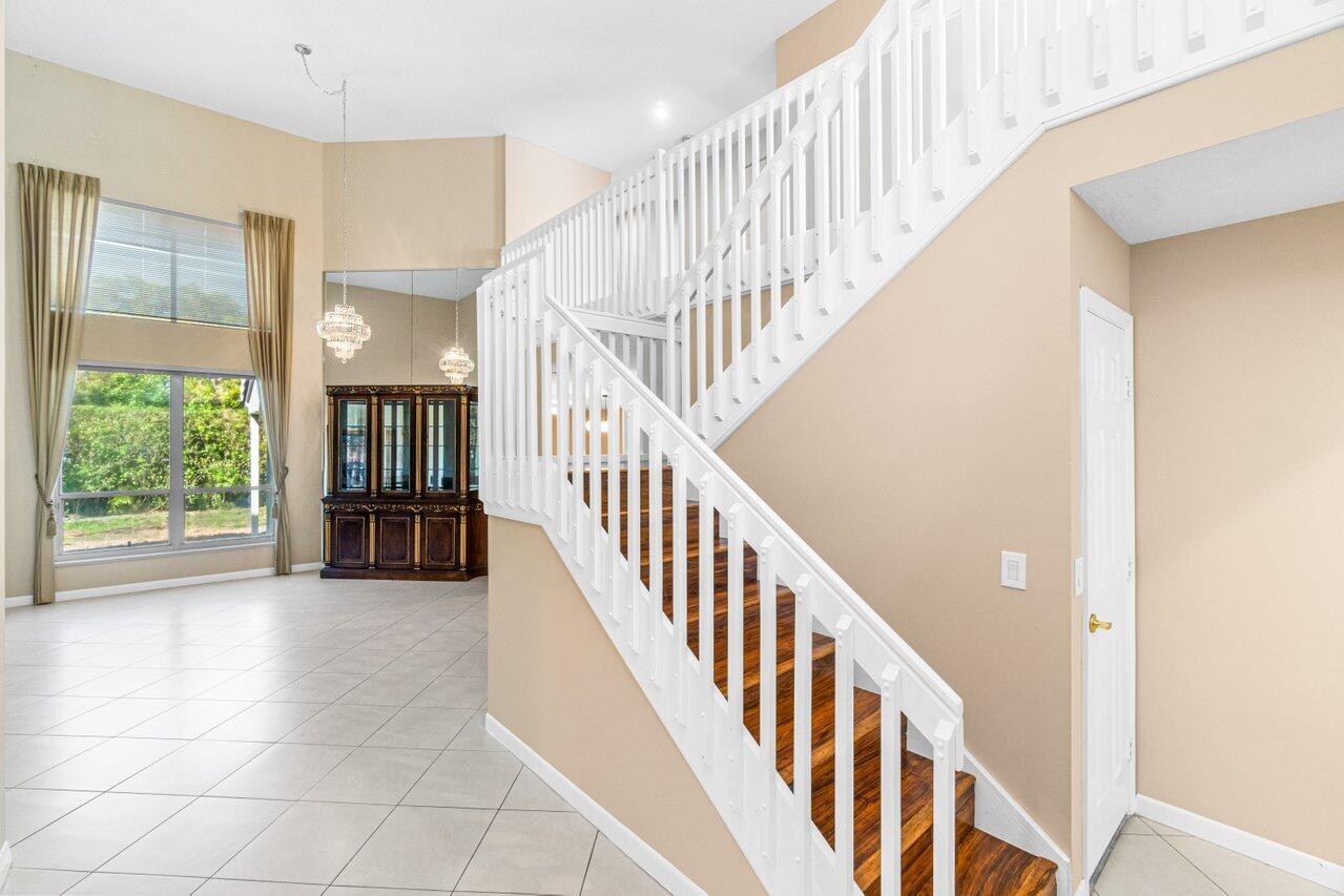 23458 Torre Circle Boca Raton, FL 33433 - Photo 5 of 36 a view of staircase with lots of windows and white walls