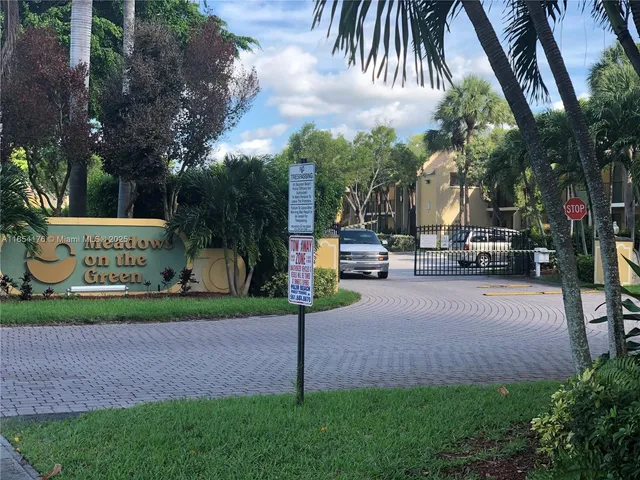 a view of street with tall buildings and a cars parked