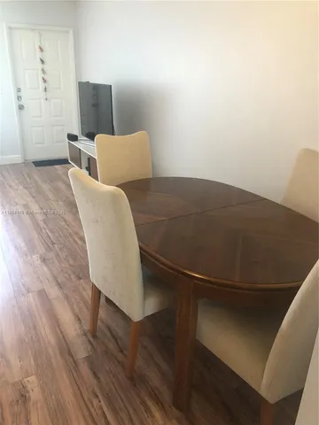 a view of a room with wooden floor and a window