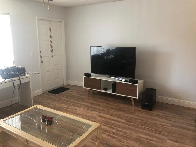 a living room with a flat screen tv and a couch