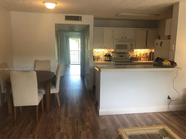a living room with furniture a window and wooden floor
