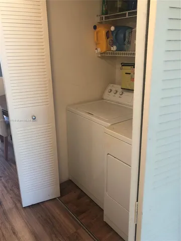 a living room with couch and a wooden floor