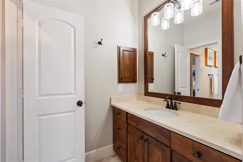 a bathroom with a sink vanity and a mirror