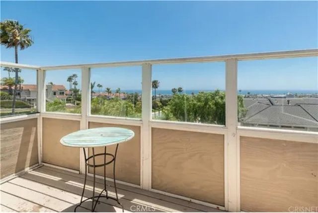 a view of a room with a table and chairs