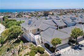 an aerial view of a house with a yard and lake view