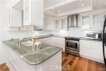 a kitchen with stainless steel appliances granite countertop a sink stove and cabinets