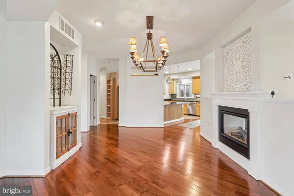 a kitchen with stainless steel appliances granite countertop a sink a stove top oven a counter space and cabinets