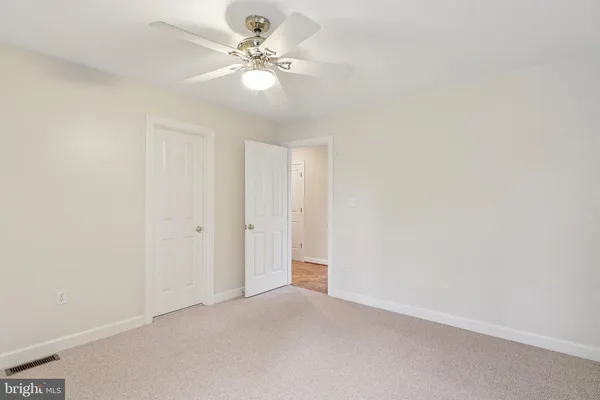 a view of a house with a yard covered in snow
