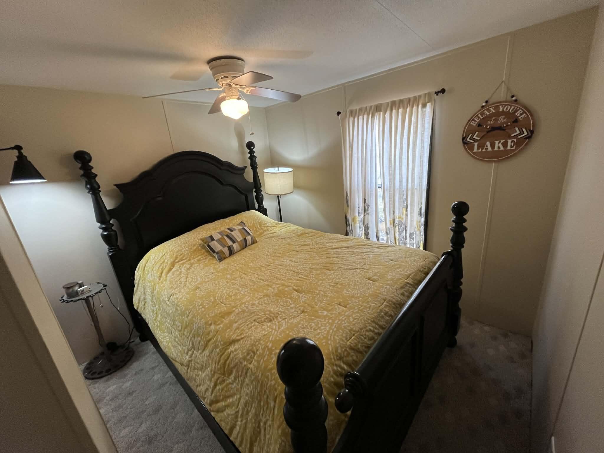512 Ridgelake Road Goodview, VA 24095 - Photo 11 of 17 a bedroom with a bed and a chandelier