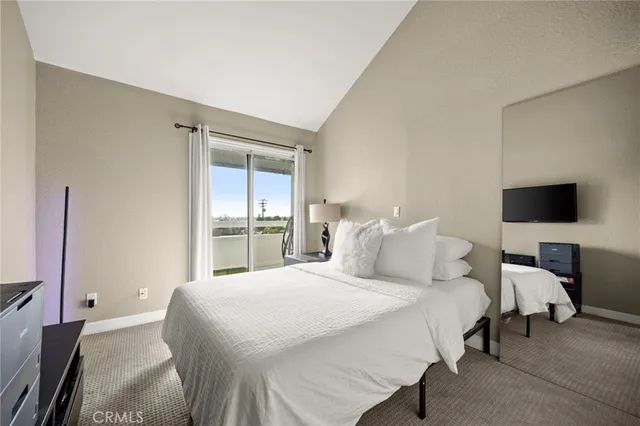 a bedroom with a bed and large window