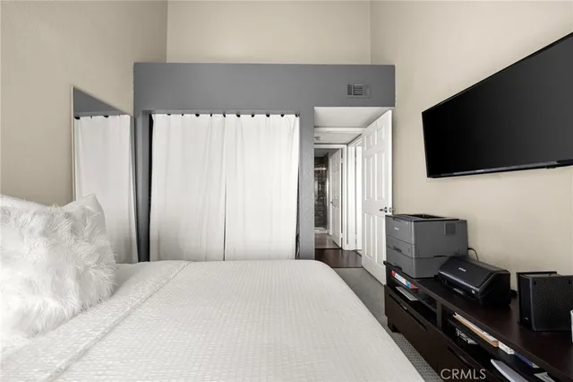 a bedroom with a bed and a flat screen tv