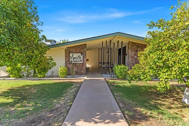 a kitchen with a table chairs and white cabinets