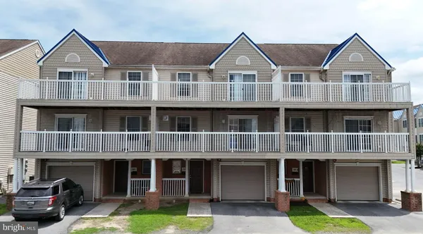 a front view of a residential apartment building with a yard