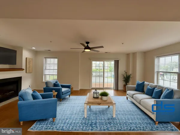 a living room with furniture fireplace and window