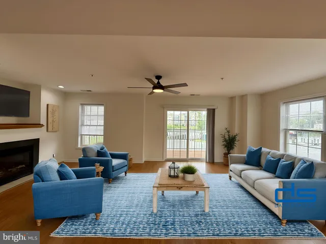 a living room with furniture fireplace and window