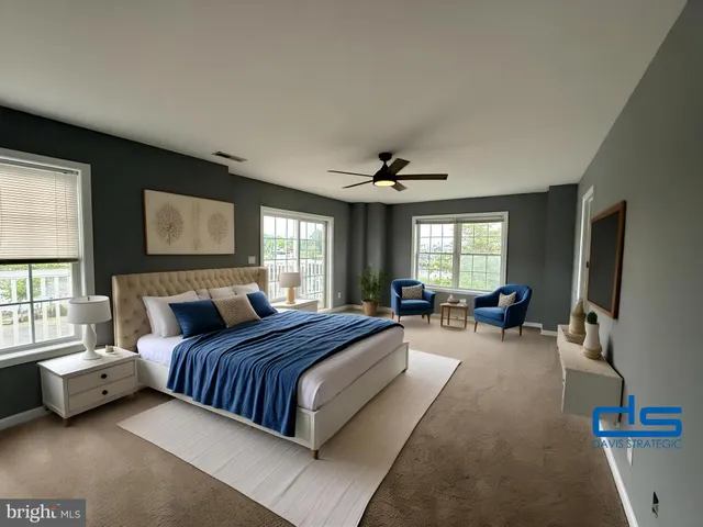 a spacious bedroom with a bed and a large window