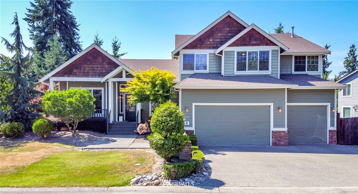 2706 91st Avenue East Edgewood, WA 98371 - Photo 1 of 40 a front view of a house with a yard and garage
