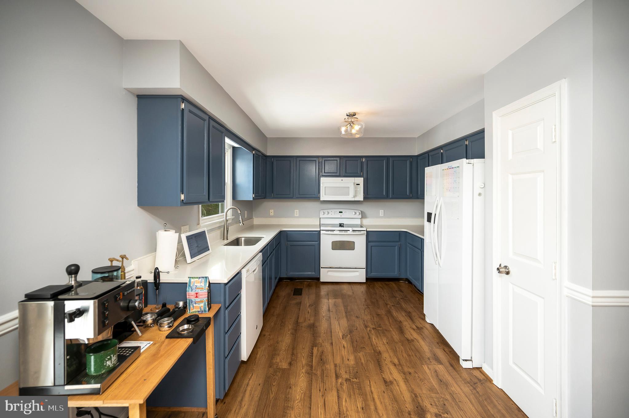 228 Choptank Road Stafford, VA 22556 - Photo 16 of 51 a kitchen with stainless steel appliances a refrigerator a sink dishwasher a stove and white countertops with wooden floor