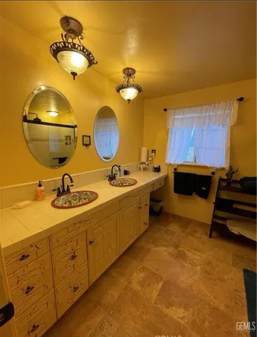 a bathroom with a sink mirror and vanity
