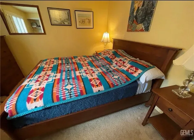 a bedroom with a bed and wall painting