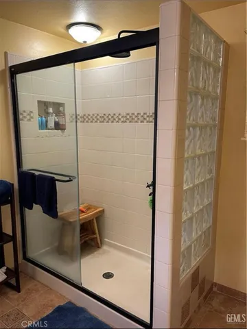 a bathroom with a glass shower door