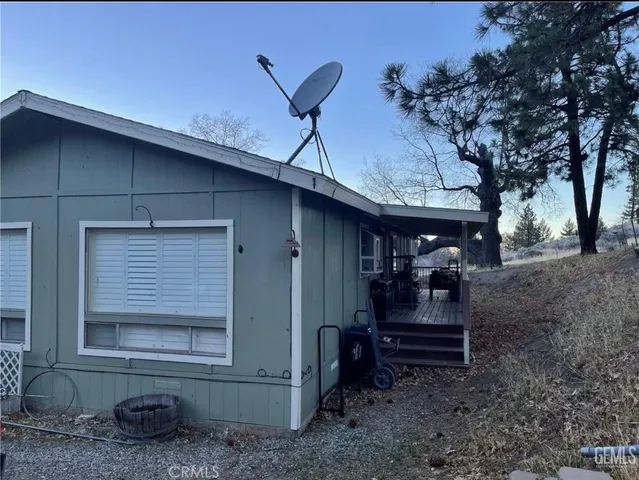 a view of house with backyard and furniture