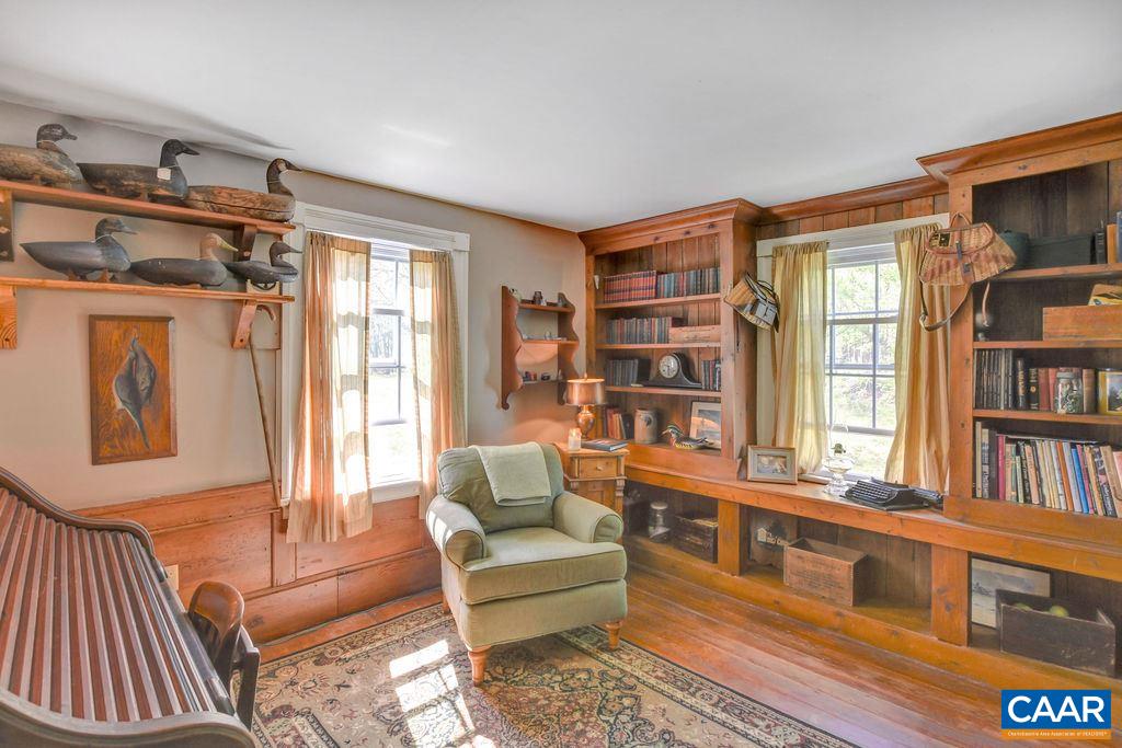 674 Octonia Road Stanardsville, VA 22973 - Photo 17 of 38 a living room with furniture a bookshelf and a window