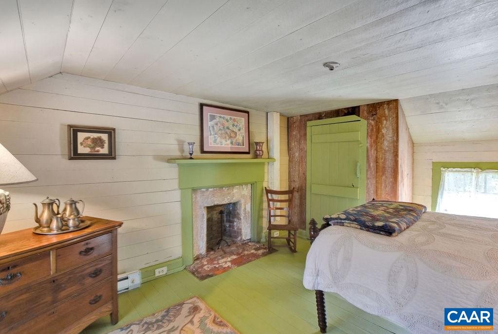 674 Octonia Road Stanardsville, VA 22973 - Photo 25 of 38 a bedroom with a bed and a fireplace