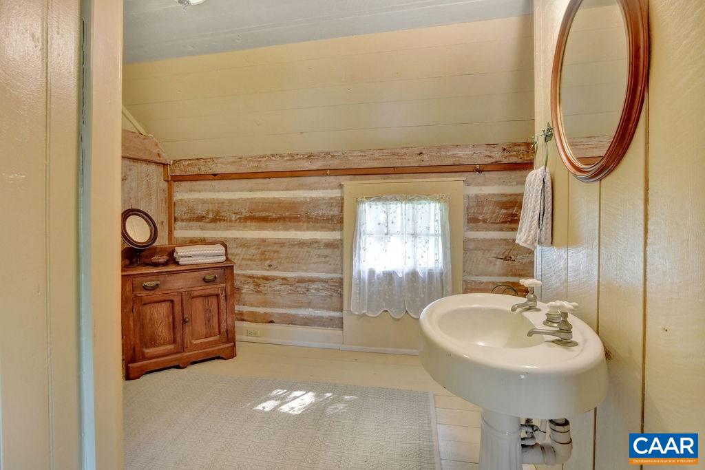 674 Octonia Road Stanardsville, VA 22973 - Photo 27 of 38 a bathroom with a sink a mirror and a shower