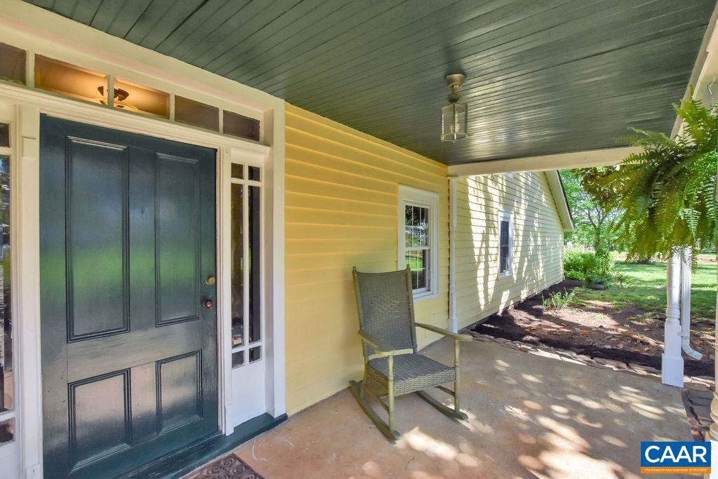 674 Octonia Road Stanardsville, VA 22973 - Photo 3 of 38 a view of a porch with a table and chairs