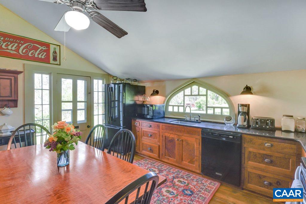 674 Octonia Road Stanardsville, VA 22973 - Photo 9 of 38 a view of a dining room and a kitchen with a table chairs