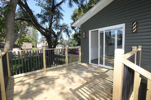 a view of a house with a wooden fence